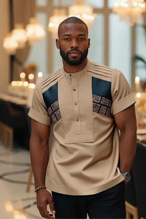 Man wearing a beige and blue patterned shirt in an elegant indoor setting