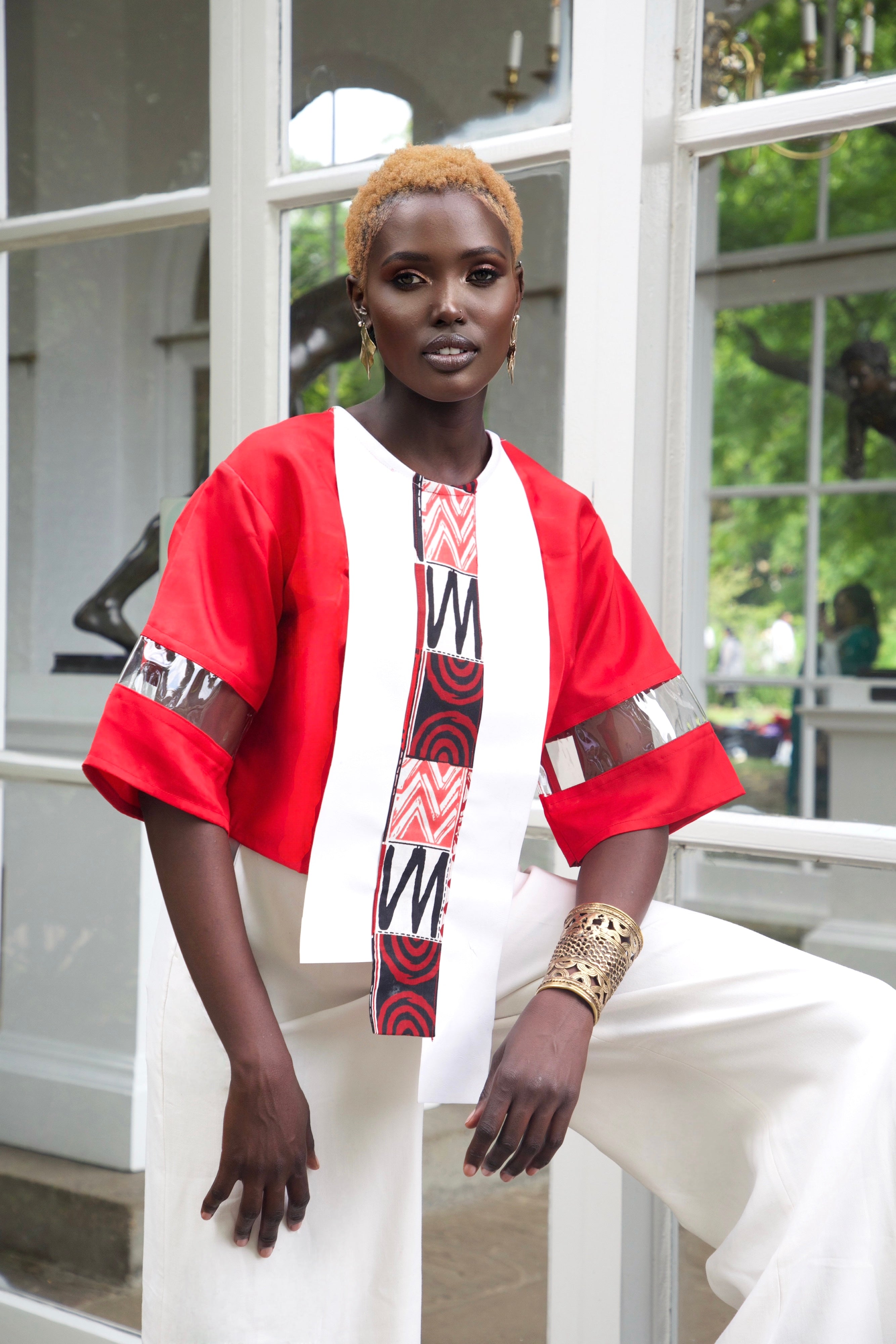 Eloli asymmetrical crop top with African wax print trim and sculptural sleeve details