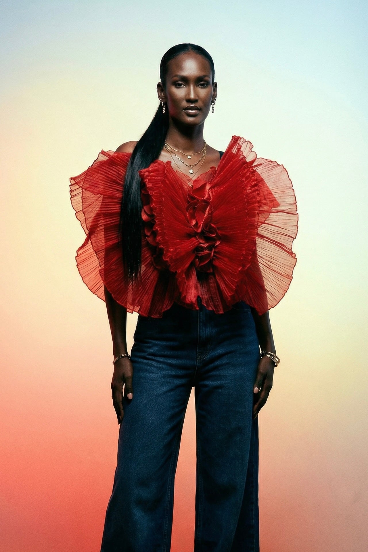 ELOLI model wearing the Tong flower blouse, a red organza statement top made in Cameroon